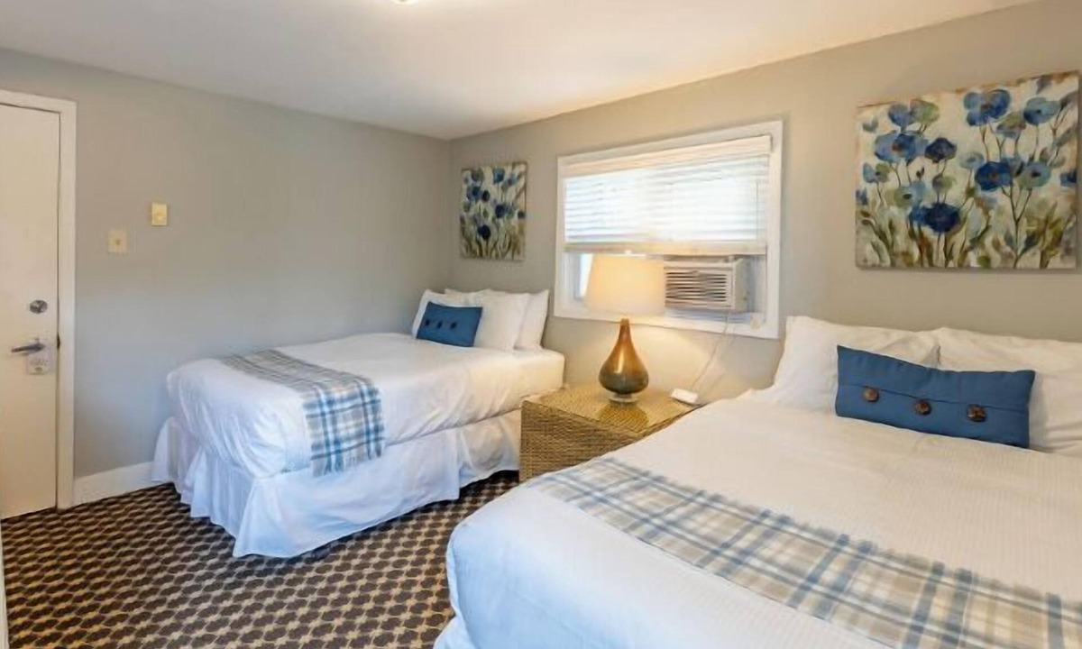 Whitehall Resort | Great room with two Full beds. Lake view from deck