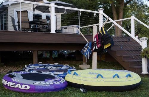 Moline House | Eclectic Riverside Home 3 Season Room Large Deck