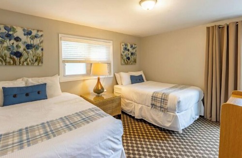 Whitehall Resort | Great room with two Full beds. Lake view from deck