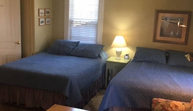 Large studio suite w/private back porch entrance one block from the beach.